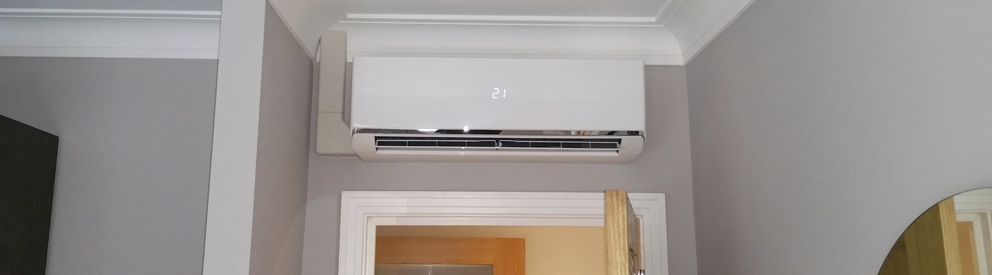 Installing internal AC to air condition an apartment in Fountain Court, Windsor in a conservation area - whisper quet high wall unit in bedroom